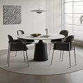 Modern Round Dining Table Set With Black Chairs Metal Legs And Abstract Wall Art