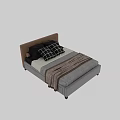 Double Bed With Brown Upholstered Headboard Black Checkered Pillows And Gray Striped Blanket