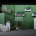 Elegant Photo Check-in Spot With Green Wall Flower Arrangements Easel Logo And White Pillars
