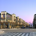 Modern Commercial Street With Multi story Buildings Storefronts Street Lamps And Crosswalks