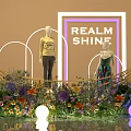 Elegant Window Display With REALM SHINE Sign Two Mannequins Colorful Flowers And Arched Lighting