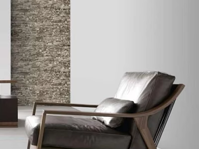 Modern Leather Single Sofa With Wooden Frame And Cushion Against Textured Wall 3d model
