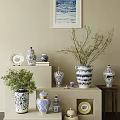 Blue and White Ceramic Vessels Jars Vases and Plates with Green Plants on Shelf