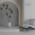Modern Leisure Chair Interior Design With White Planter Green Plant Gray Wall And Soft Lighting