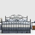 Double Bed With Black Iron Frame Ornate Design Blue Floral Bedding And Nightstand