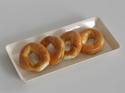 Freshly Baked Four Golden Brown Bagels on a White Rectangular Plate 3d model