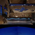 Unique Restaurant Interior Design With Cave Like Ceiling Blue Art Bar Counter And Black Stools