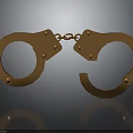 Detailed Golden Handcuffs With Metallic Shiny Finish On Reflective Surface