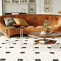 Modern Curved Brown Sofa And Round Coffee Table Set With Decorative Pillows Plants And Books