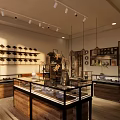 Elegant Jewelry Store Interior With Glass Display Cases Hanging Lights And Wooden Shelves