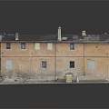 Old Two Story Building With Weathered Brown Facade Dark Roof Chimneys And Windows