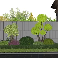 Beautiful Garden Landscaping With Well Trimmed Shrubs Against Gray Wall And Purple Green Plants