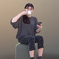 Woman Sitting On Round Stool Using Mobile Phone And Drinking Coffee In Casual Outfit