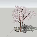 Cherry Blossom Tree With Pink Flowers Stones And Statue Under Blue Sky And White Clouds