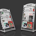 Two White Metal Magazine Racks with READ Sign Holding Magazines Newspapers and Wheels