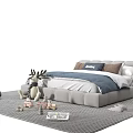 Modern Gray Double Bed With Blue Bedding Pillows On Carpet And Stuffed Deer Toys