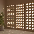 Geometric Room Divider with Circular Square Cutouts and Light Projection in Interior with Potted Plant