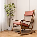 Comfortable Wooden Rocking Chair With Red Cushion Mesh Backrest And Green Plant