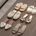 Comfortable Neutral Toned Slippers with Various Fabric and Leather Styles on Wooden Floor