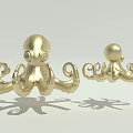 Two Golden Octopus Decorative Sculptures With Curled Tentacles And Shiny Finish