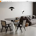 Round Black Dining Table With Rattan Back Chairs White Vase And Pendant Light In Modern Space