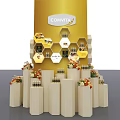 Comvita Product Display With Yellow Background Hexagon Shelves White Pillars And Flower Decorations
