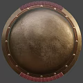 Ancient Bronze Shield with Red Leather Edging and Metal Rivets as Historical Weapon