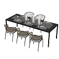 Garden Landscape Outdoor Dining Setup With Rattan Chairs Tableware And Water Glasses