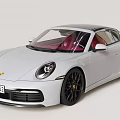 White Porsche Sports Car With Black Alloy Wheels And Sleek Front Design