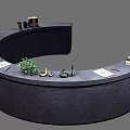 Curved Dark Reception Desk With Green Plant Books And Decorative Items
