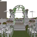 Detached Villa Outdoor Area With Red Brick Exterior White Arbor Vines Greenery And Lawn Chairs