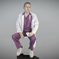 Man In Purple Scrubs And White Lab Coat Sitting On Chair With Gray Background
