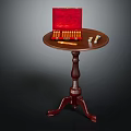 Classic Dark Brown Wooden Round Accent Table With Three Legs And Red Box On Top