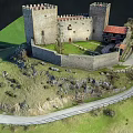 Medieval Castle Architecture With Stone Walls Towers On Green Hill And Path