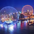 Night View Of City Skyline With Illuminated Spherical Structures And Waterfront