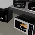 Three Black And Silver Microwaves On Modern Kitchen Countertop With Cabinets