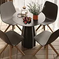 Round Dining Table Set with Four Black Chairs Wooden Legs and Decorative Vase Plants