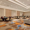 Luxury Mahjong Hall Interior With Multiple Tables Chairs Wine Cabinet Decorative Paintings And Patterned Carpet
