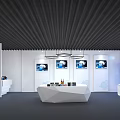 Contemporary Exhibition Space With White Irregular Reception Desk Black Ceiling Wall Artworks And Digital