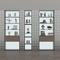 Three Modern Decorative Cabinets With Multiple Shelves Displaying Figurines Vases Books And Plants