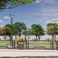 Decorative Gray Road Guardrail With Yellow Flowers And Green Trees Along Urban Path