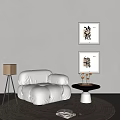 White Single Sofa With Beige Wall Two Framed Artworks Round Coffee Table Lamp And Rug