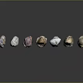 Natural Stone Pebbles In Various Colors And Shapes Arranged On Black Background