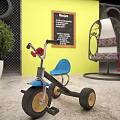 Kids Tricycle With Blue Seat Red Handlebar Yellow Wall Chalkboard And Green Plant