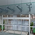 Modern Glass Entrance Door With Aluminum Frame Potted Plants And Ceiling Lighting