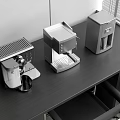 Modern Black Countertop With Stainless Steel Kitchen Appliances And Coffee Maker