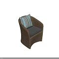 Stylish Wicker Outdoor Chair with Striped Back Cushion and Gray Seat Cushion