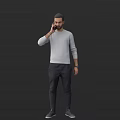 Man Standing And Talking On Phone In Gray Long Sleeved Shirt And Dark Pants