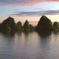 Calm Water Reflecting Distant Green Mountains Under Pink And Blue Sunset Sky With Clouds