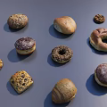 Assorted Bread Desserts Including Donuts Cookies With Sesame Seeds Chocolate Coating On Gray Background